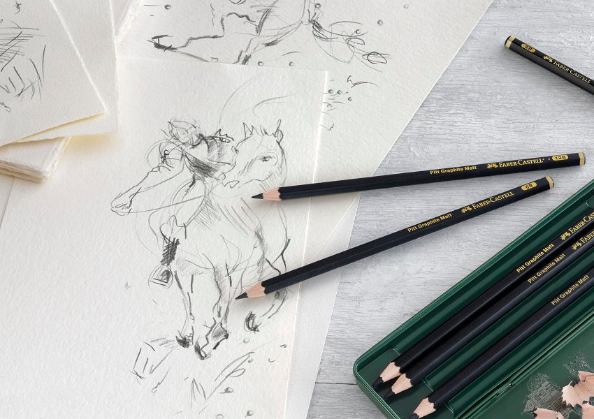Faber-Castell blyanter på en blok med billede af en person